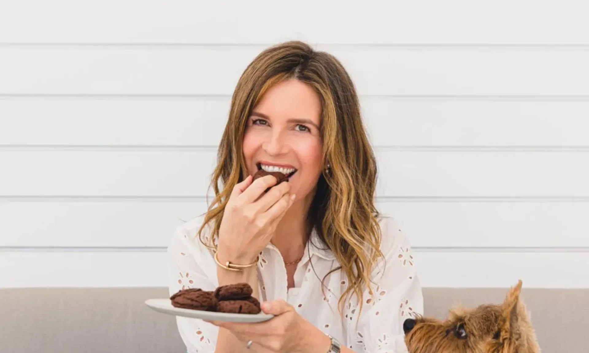 A woman is enjoying her delectable Fudgy Chocolate Cookies.