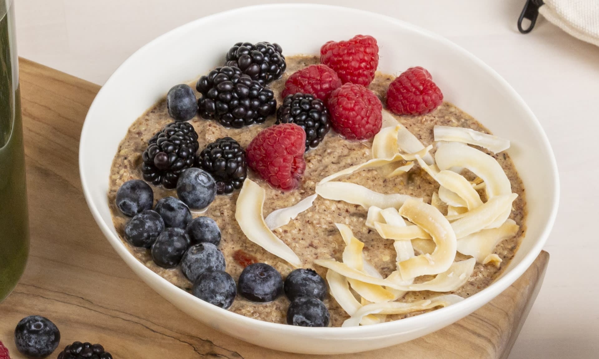 A bowl of delectable granola with berries and dried coconut at display.