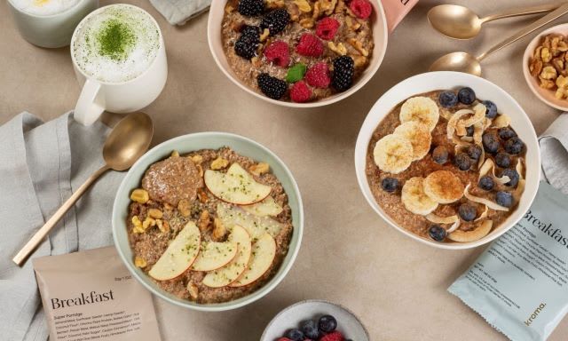 Three bowls of prepared Kroma Super Porridge with various toppings.