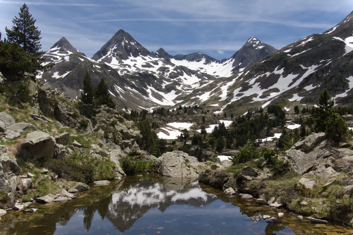 Small lake near the refuge reflecting the mountains