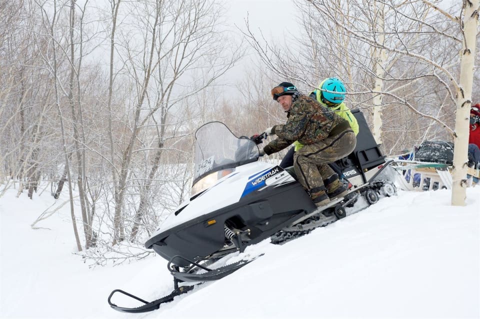 Trying to help balance the snowmobile. Photo courtesy of Martin Hartley