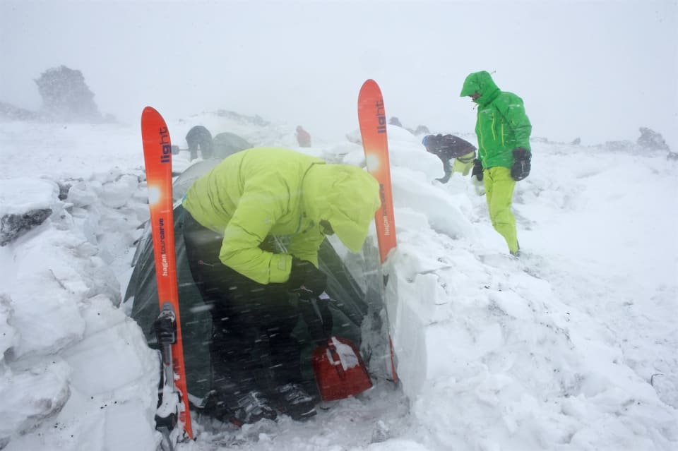 Clearing out the porch area. You can see how the wind has sculpted the snow blocks and see the volcanic rocks embedded in the snow. Photo courtesy of Martin Hartley