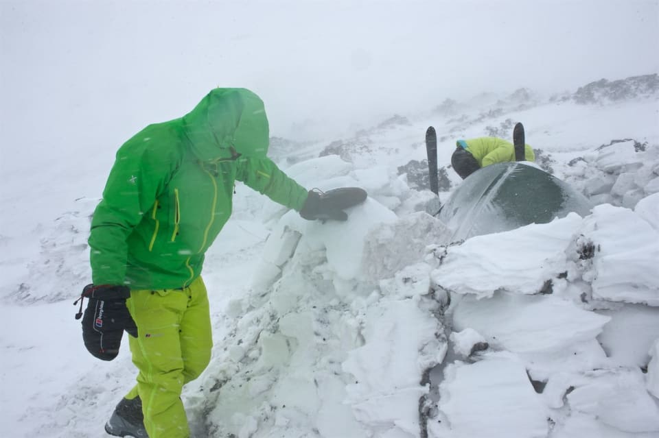 Surveying the damage and repairing, notice how the blocks of snow have been calved by the wind and the rocks embedded in the snow. Photo courtesy of Martin Hartley