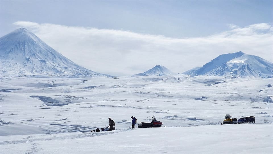 One of the snow mobiles stuck in the softening snow