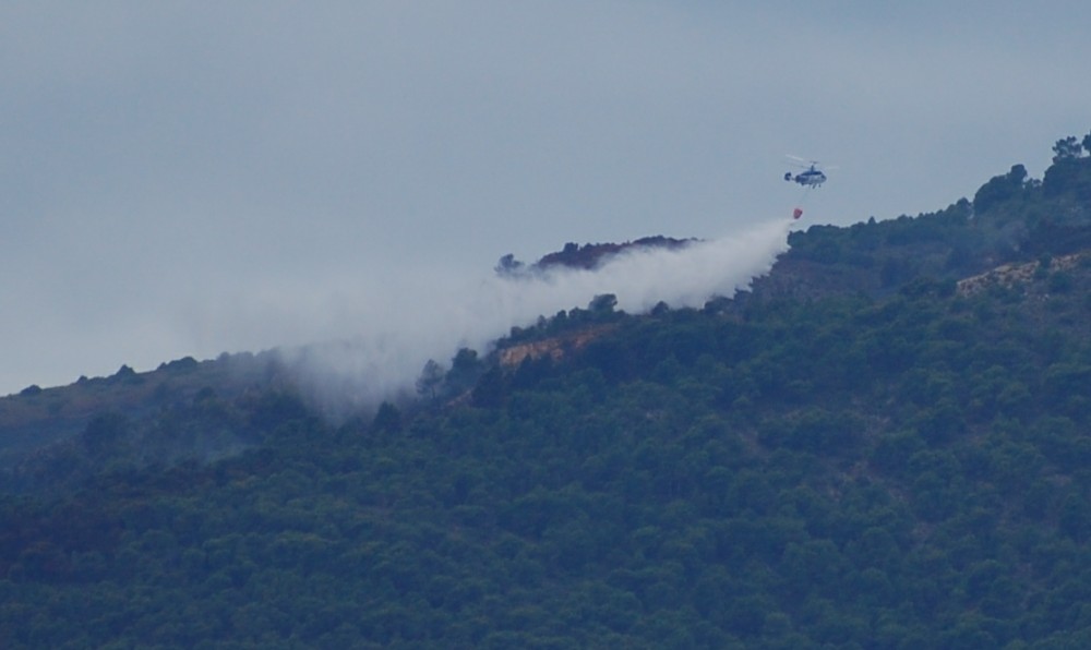 A big bucket load of water being dropped by one of the 12 helicopters