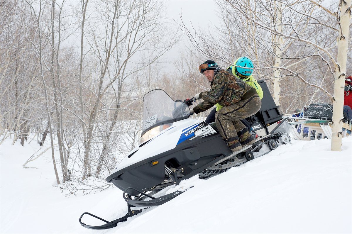Trying to help balance the snowmobile. Photo courtesy of Martin Hartley