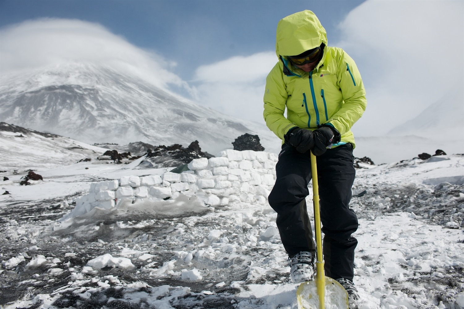 Me digging up snow to re-enforce the snow wall during a break in the weather. Photo courtesy of Martin Hartley