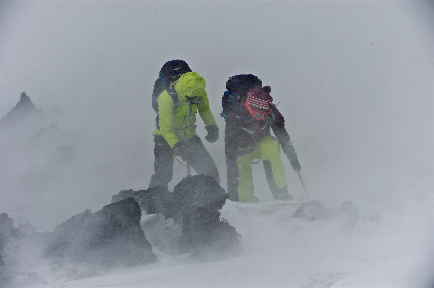 Julia and me bracing ourselves against the wind, ice axes in the ground to stop us getting blown away. Photo courtesy of Martin Hartley