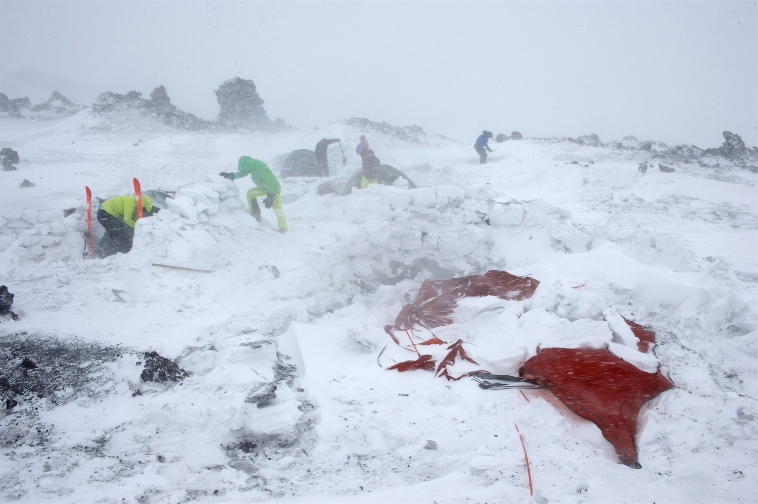 Everyone busy in camp trying to repair the snow walls. The left overs of Julia and Warwicks tent. Photo courtesy of Martin Hartley