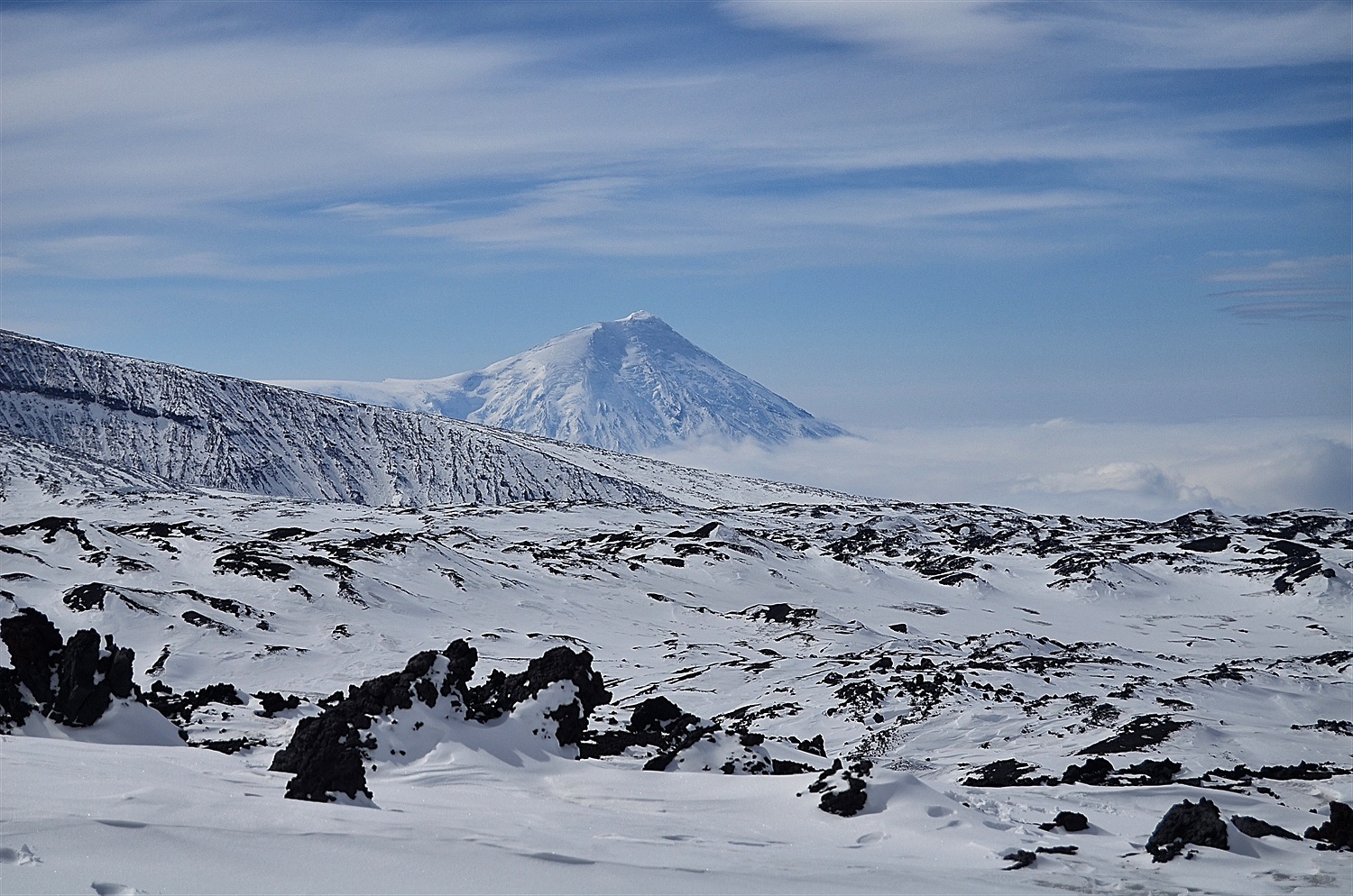 The lava erupting Tolbachik with the cloud coming up the valley