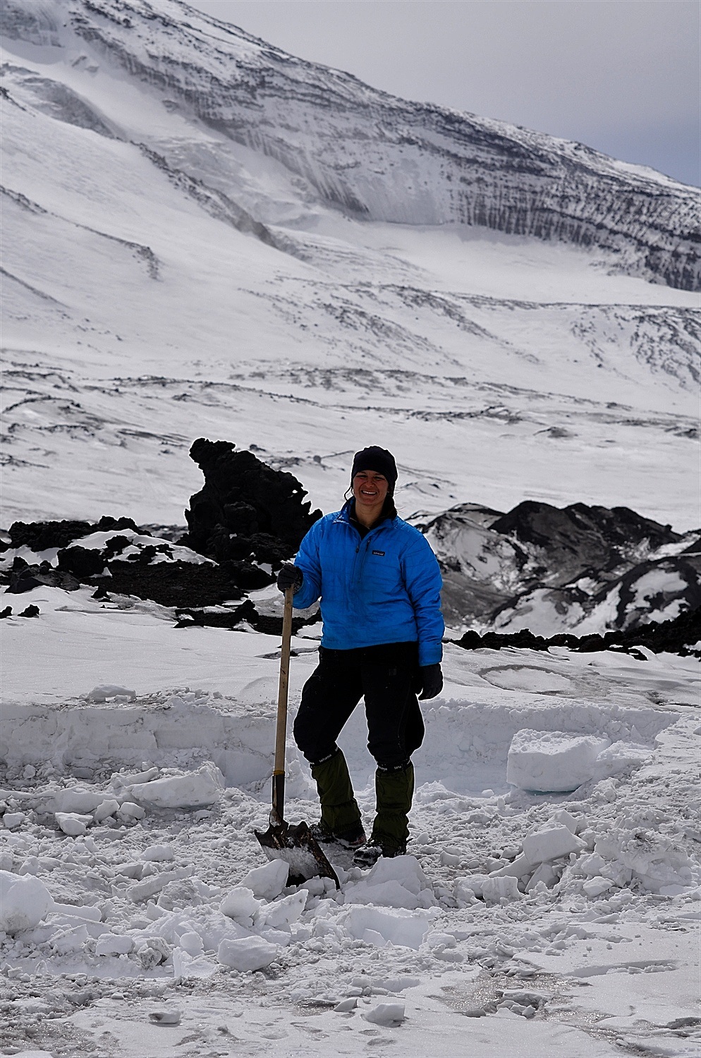 Elena taking a rest from making blocks of snow to re-enforce the snow wall on the kitchen