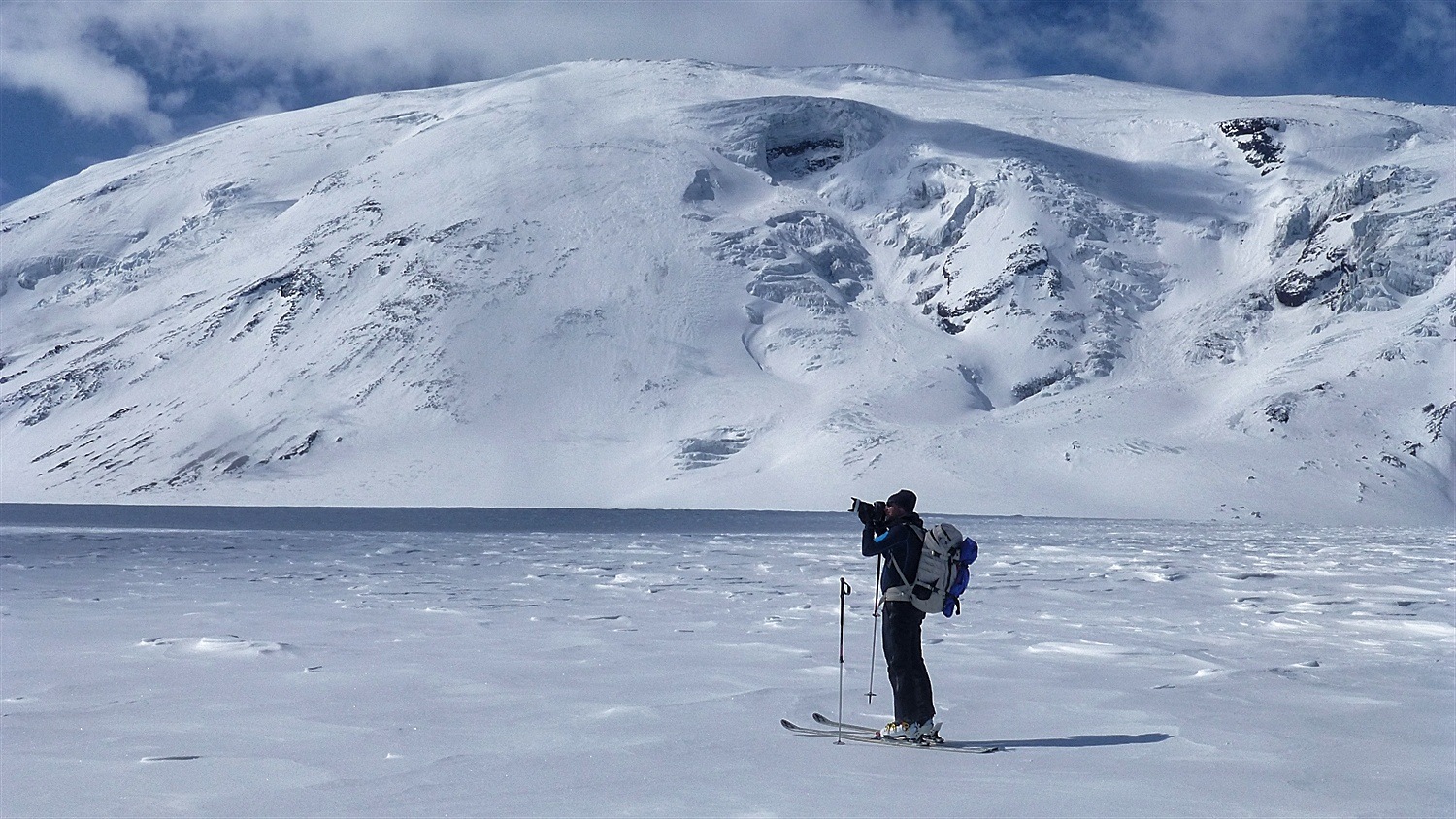 Martin taking a photo with volcano Ushkovsky behind him