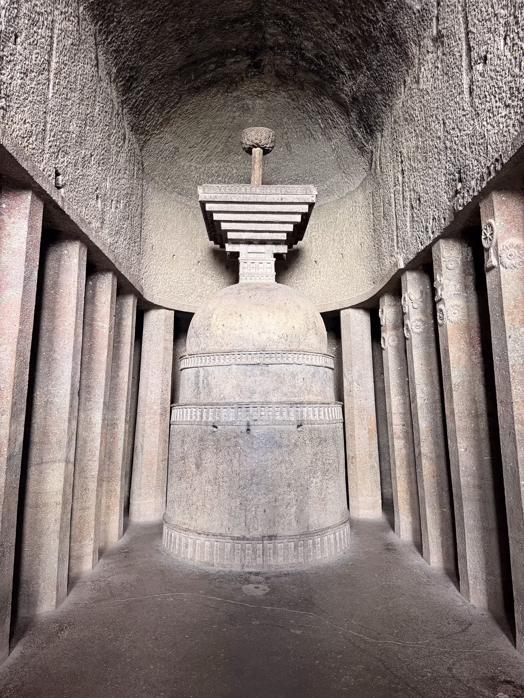 Ancient monolithic stone stupa inside the peaceful inner sanctum of Bedse Caves