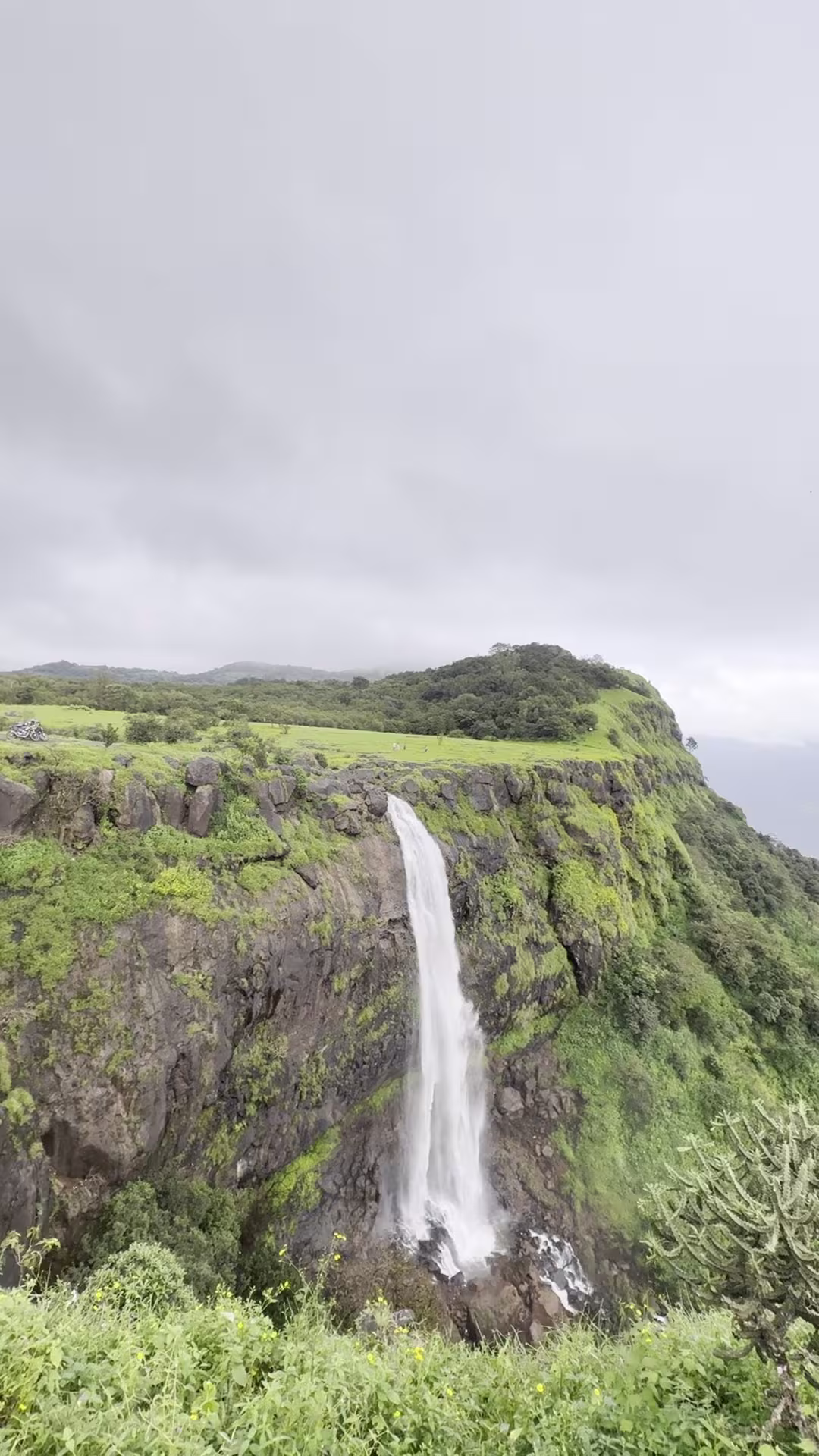 Massive waterfall cascading off the Madhe Ghat cliff edge into the Konkan valley below