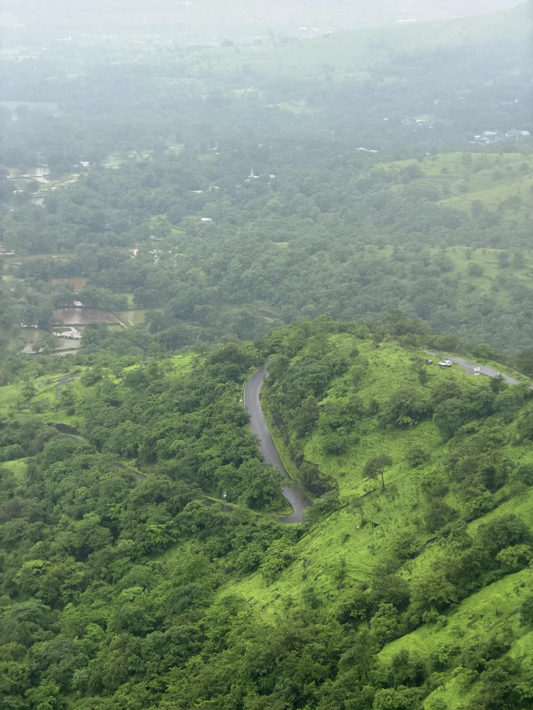 The narrow winding single-lane tarmac carving through the hills of Pabe Ghat
