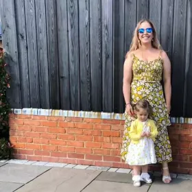 image of owner Samantha standing with her baby daughter
