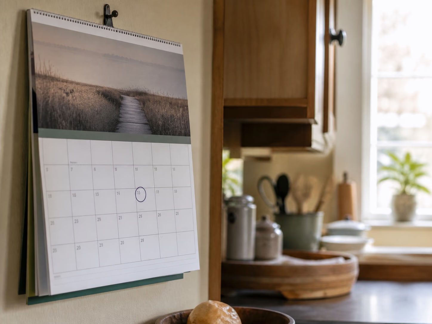 A kitchen calendar with a birthday month circled in pen.