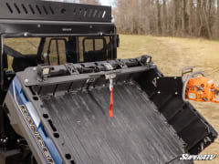 Empty tilted Ranger bed with the winch crossbar and two cube lights mounted at the front.