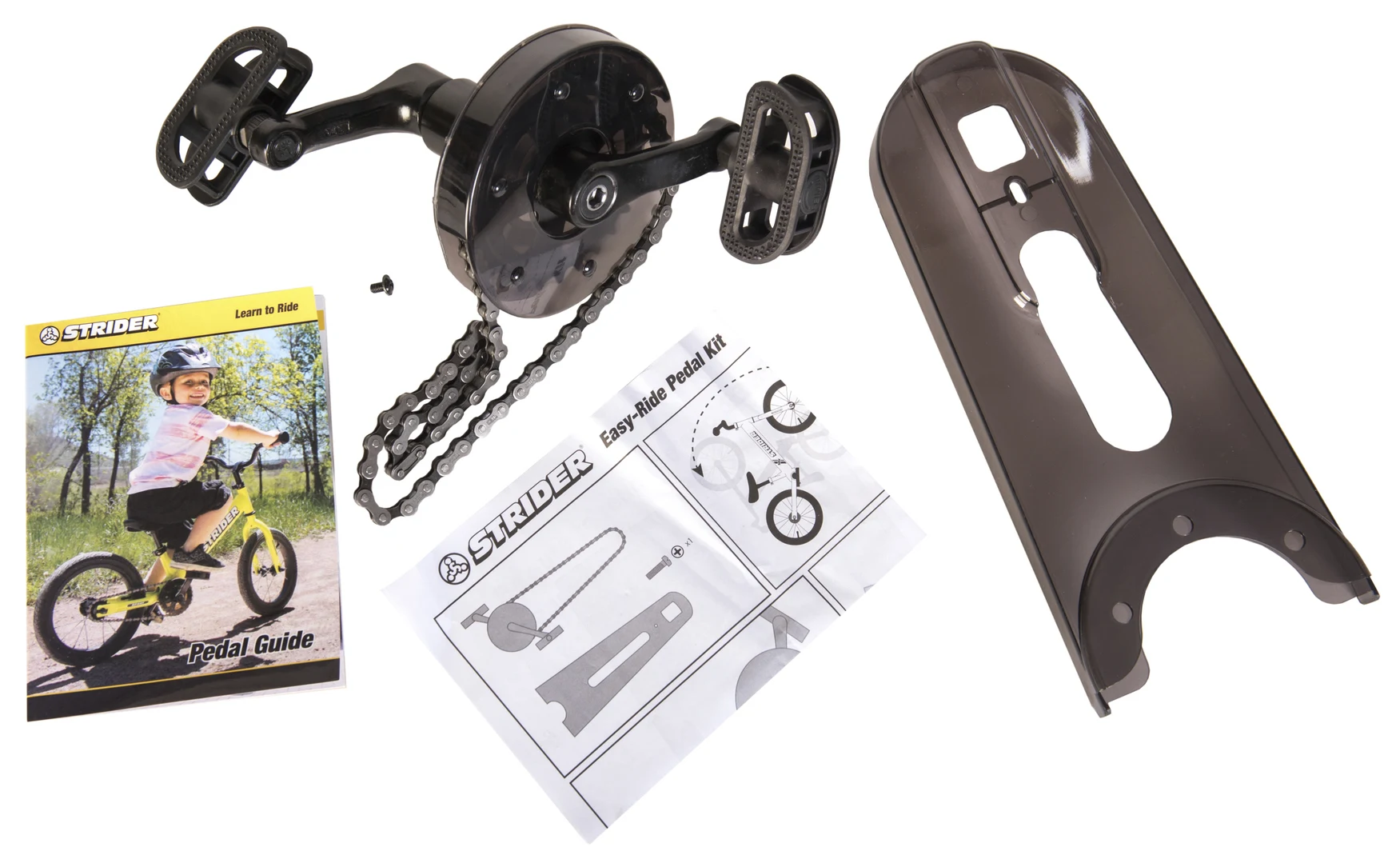 Strider 14x Easy-Ride Pedal Kit laid out with chain guard, instructions, and hardware