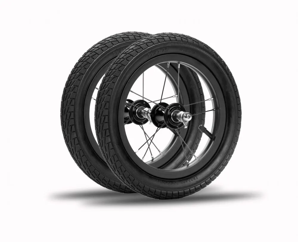 Pair of black Strider High-Traction wheels with rubber tires and axle hardware