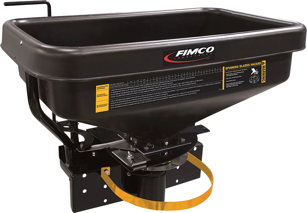 FIMCO dry material spreader with black hopper, angled view showing the spinner, control handle and yellow guard