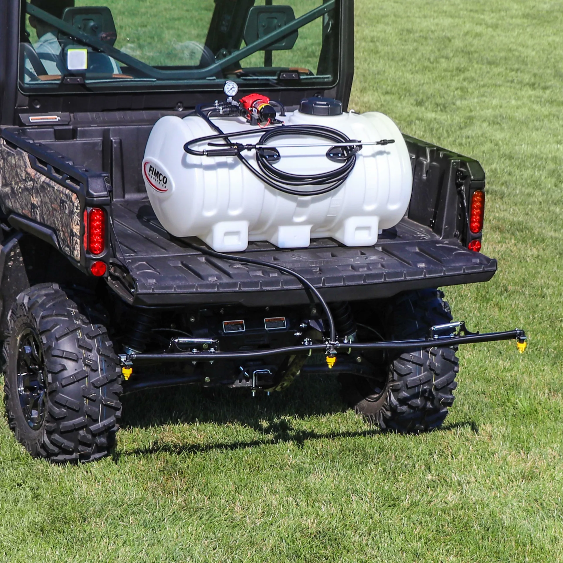 FIMCO 45-gallon Value Series sprayer in a UTV cargo bed with three-nozzle boom extended behind the vehicle