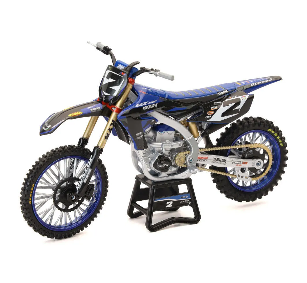Blue and white New-Ray 1:6-scale Cooper Webb Star Racing Yamaha YZ450F model on a stand, right side view