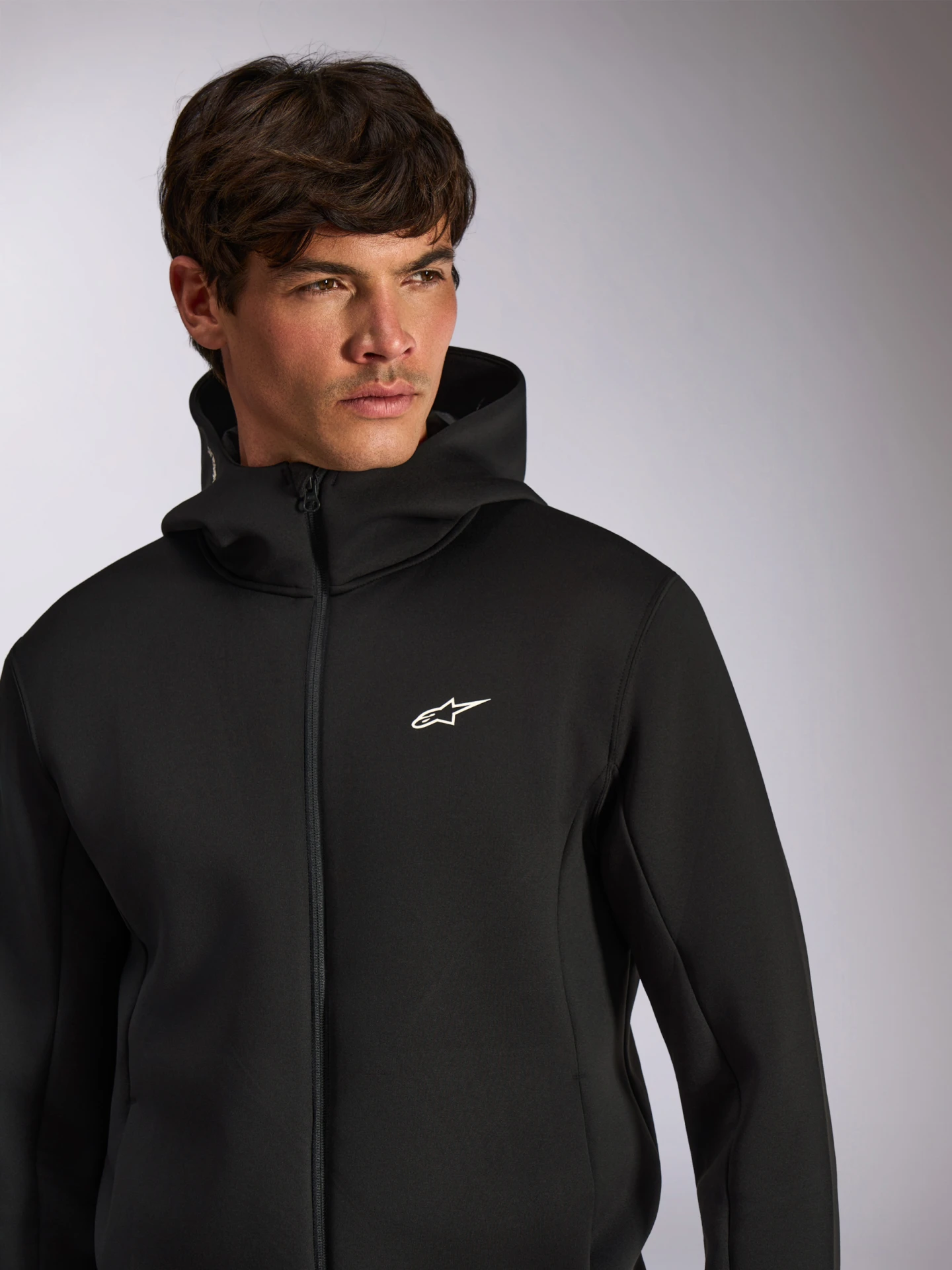 Model wearing the black Alpinestars Cypher zip hoodie, front view