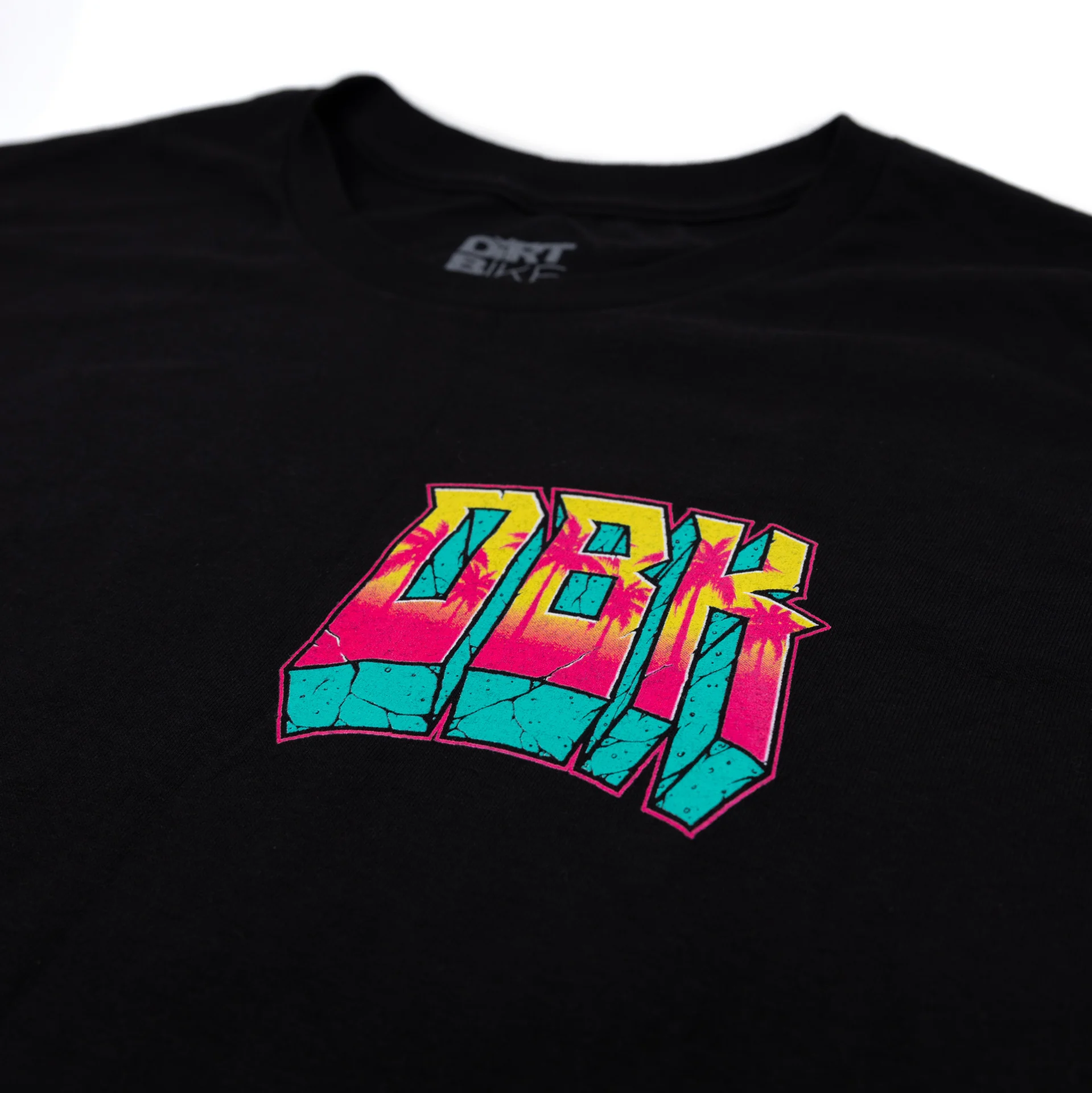 DBK Block X Block Tee in black, close-up of the front chest logo and collar