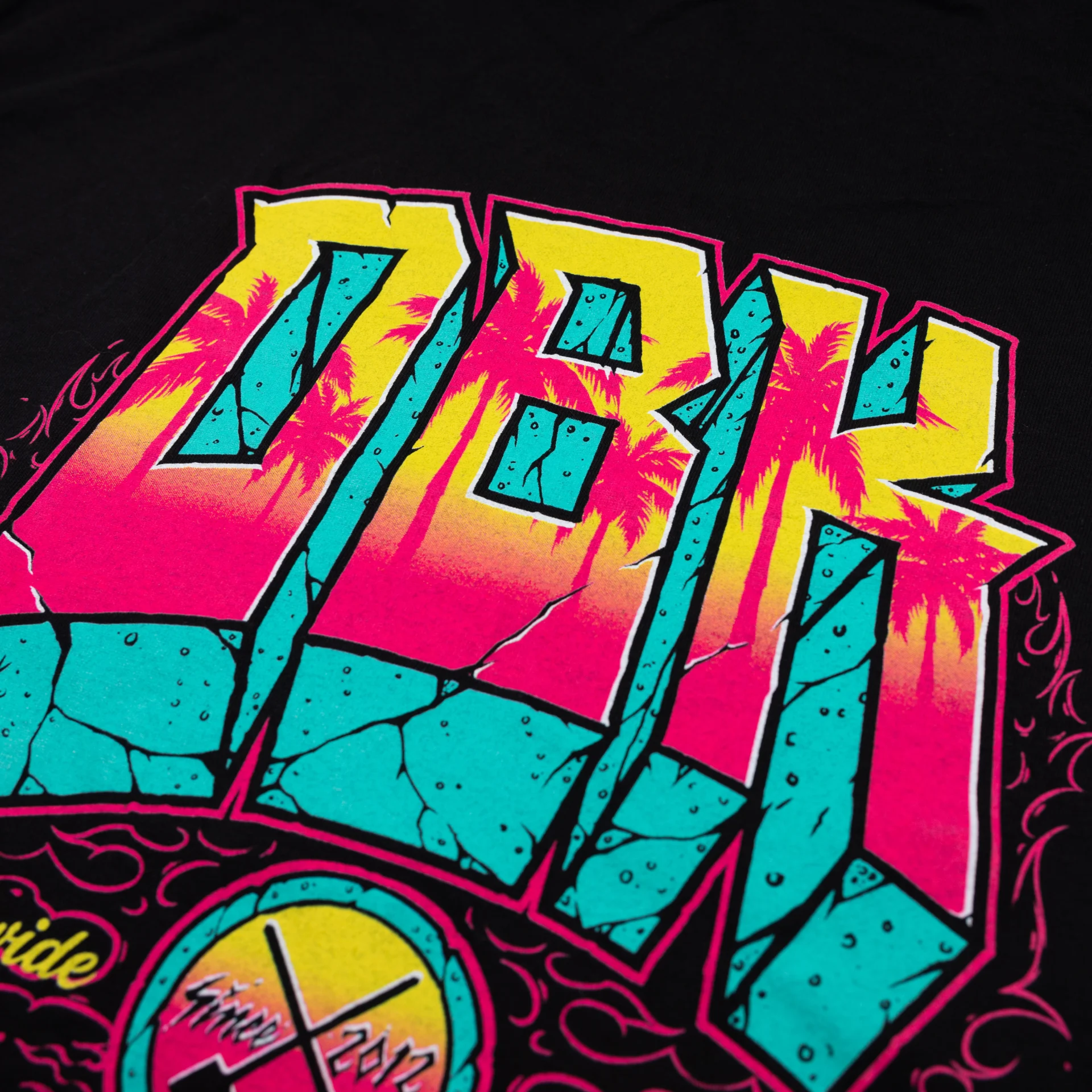 DBK Block X Block Tee in black, tight close-up of the back DBK lettering