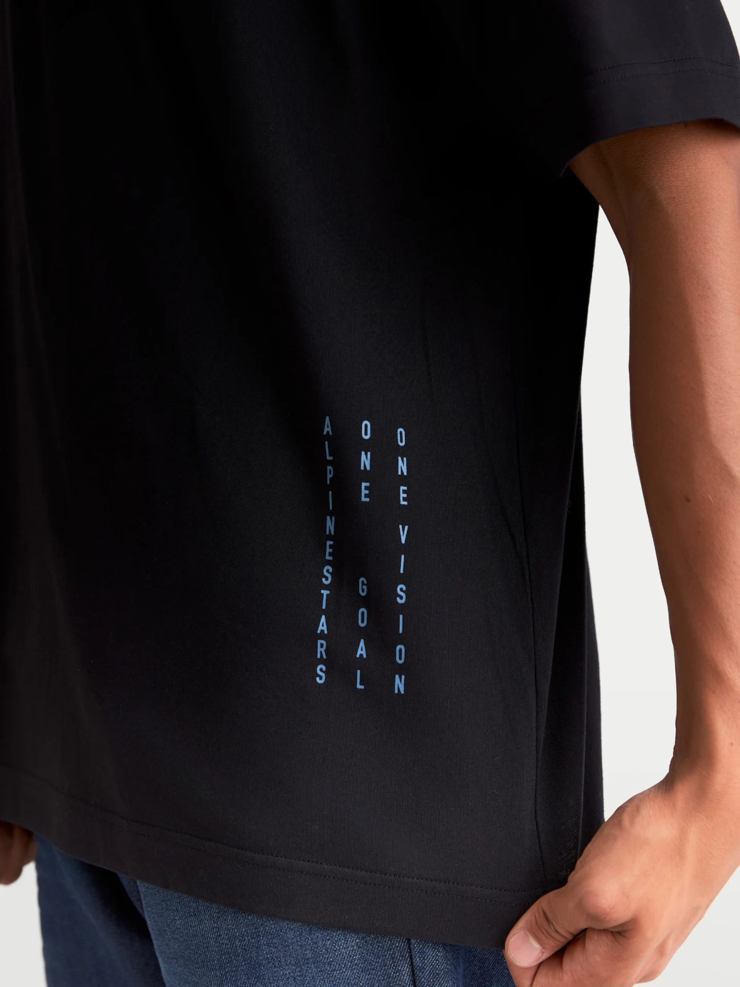 Alpinestars Chalk Oversized Tee in black, side detail with vertical text print near the hem