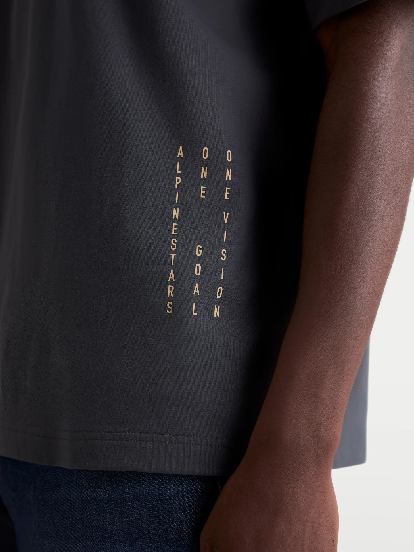 Alpinestars Chalk Oversized Tee in charcoal, side detail with vertical text print near the hem