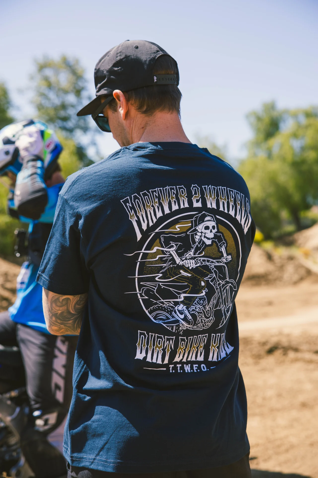 DBK Ghost Rider Tee in navy worn at a track, back view showing the skeleton rider graphic