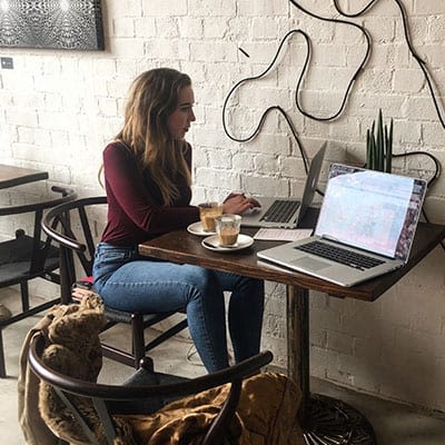 Bethany Barley sat at a cafe table facing a laptop