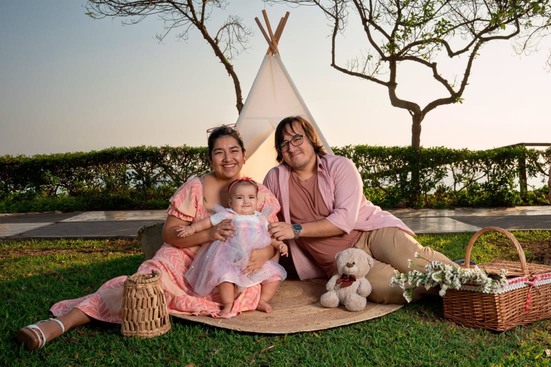 Sesión de fotos familiar en exteriores en Lima: mamá, papá y su bebé frente a un tipi