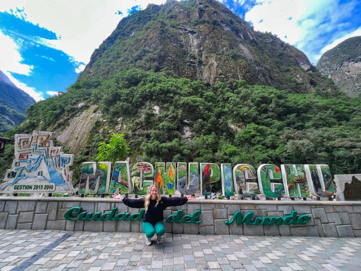 Machu Picchu sign in front of mountain in Aguas Calientes, Peru
