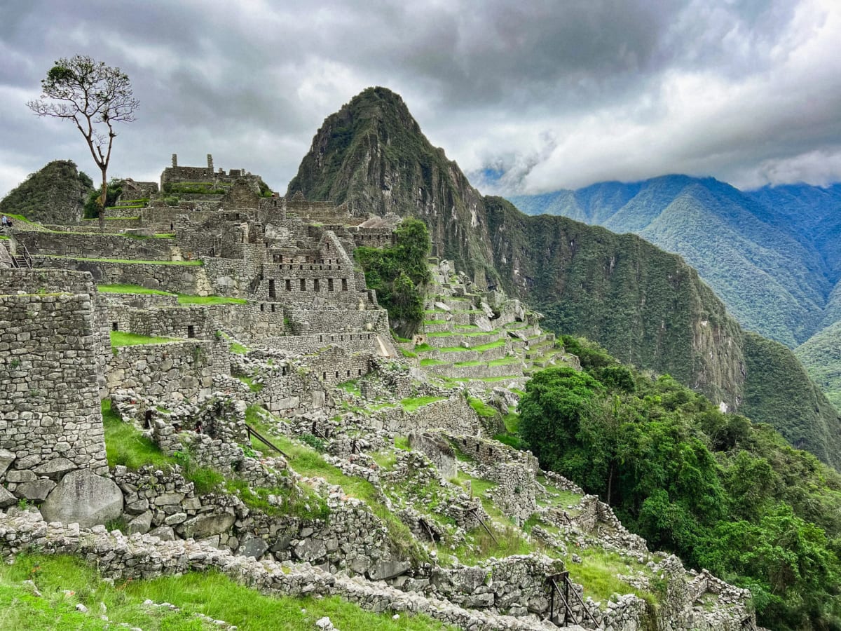 Girl sitting in front of the view at Machu Picchu