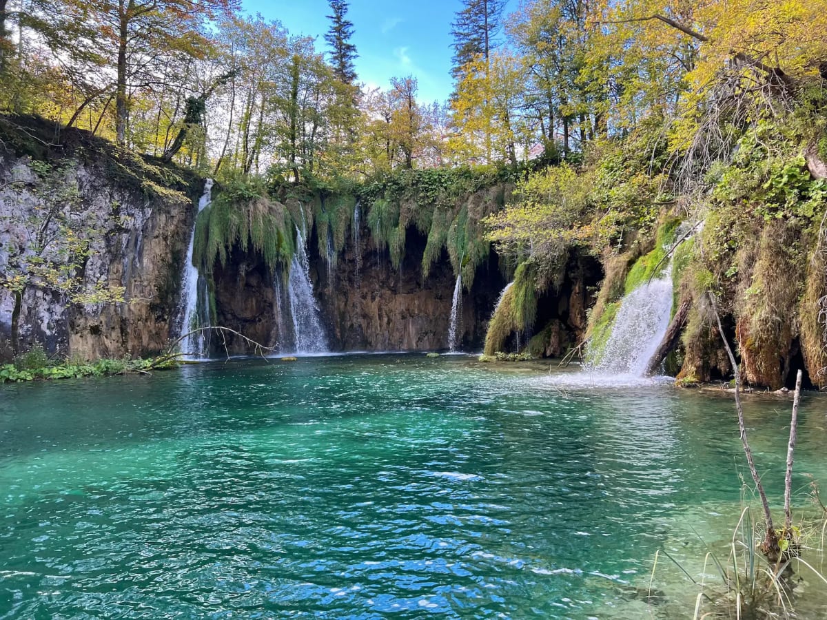 Waterfalls flowing into a lake at Plitvice Lakes National Park in Croatia