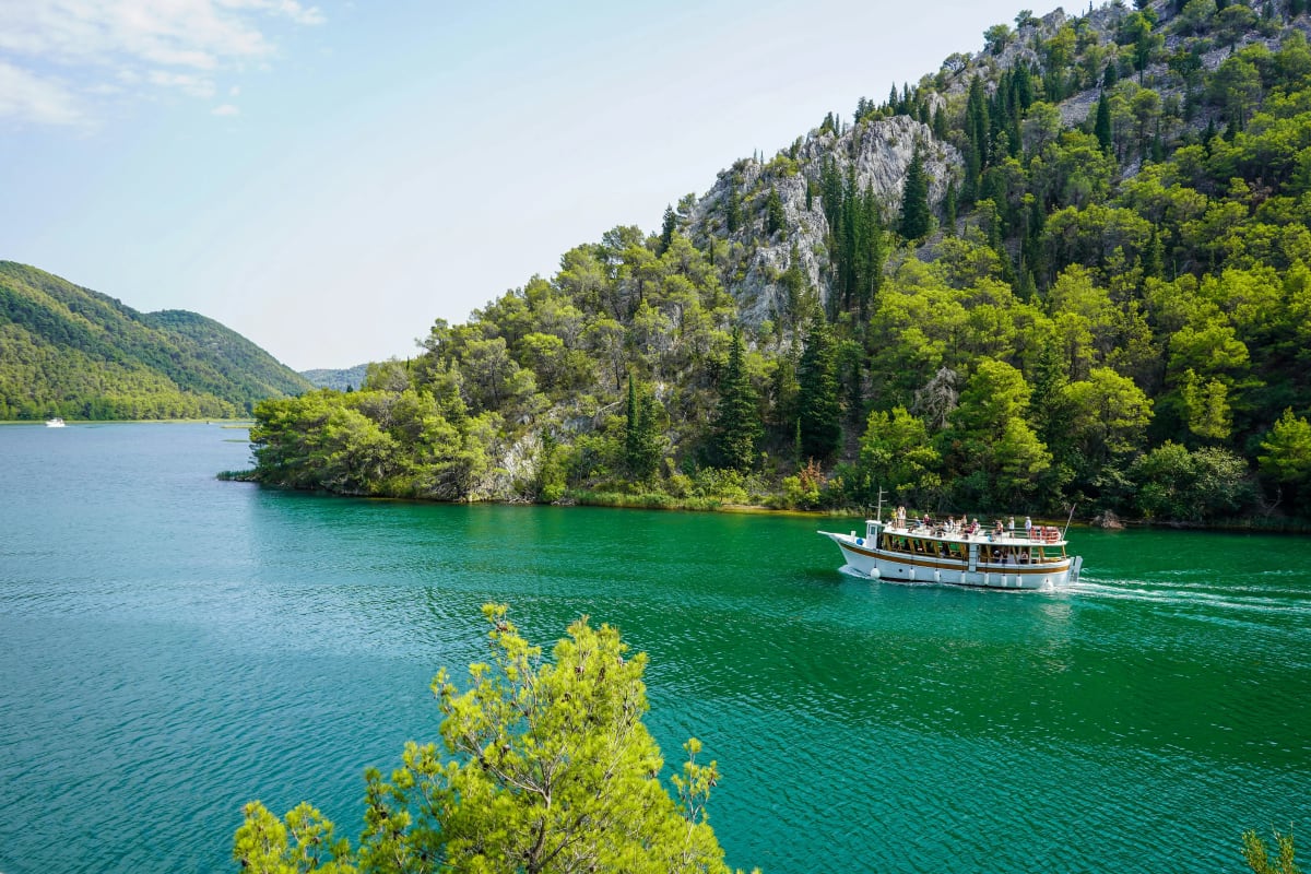 National park boat tour heading down the Krka river in Croatia