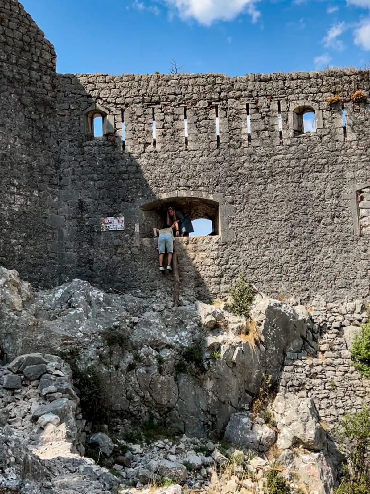 Climbing into the window of the Fortress of Kotor in Kotor Montenegro