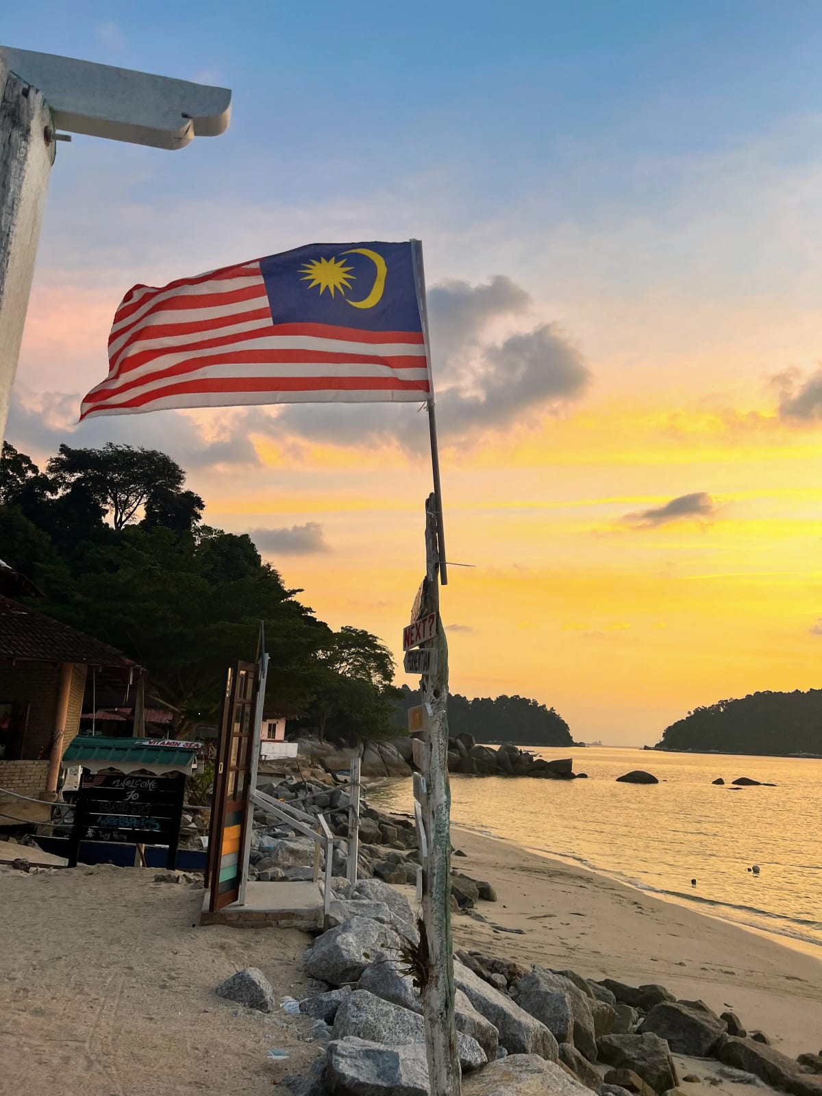 Malaysian Flag with Sunset Background