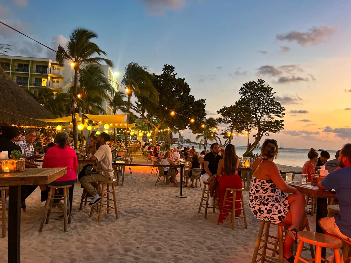 Restaurant on the sand during sunset in Palm Beach, Aruba