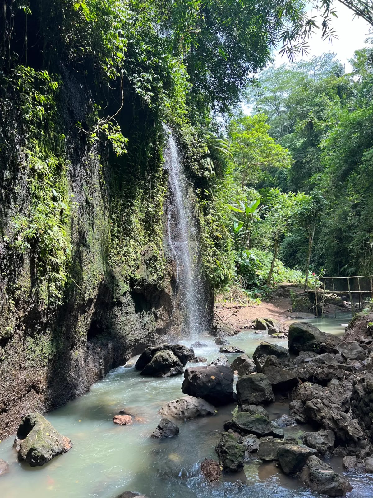 Waterfall trickling down a cliffside in the Balinese jungle