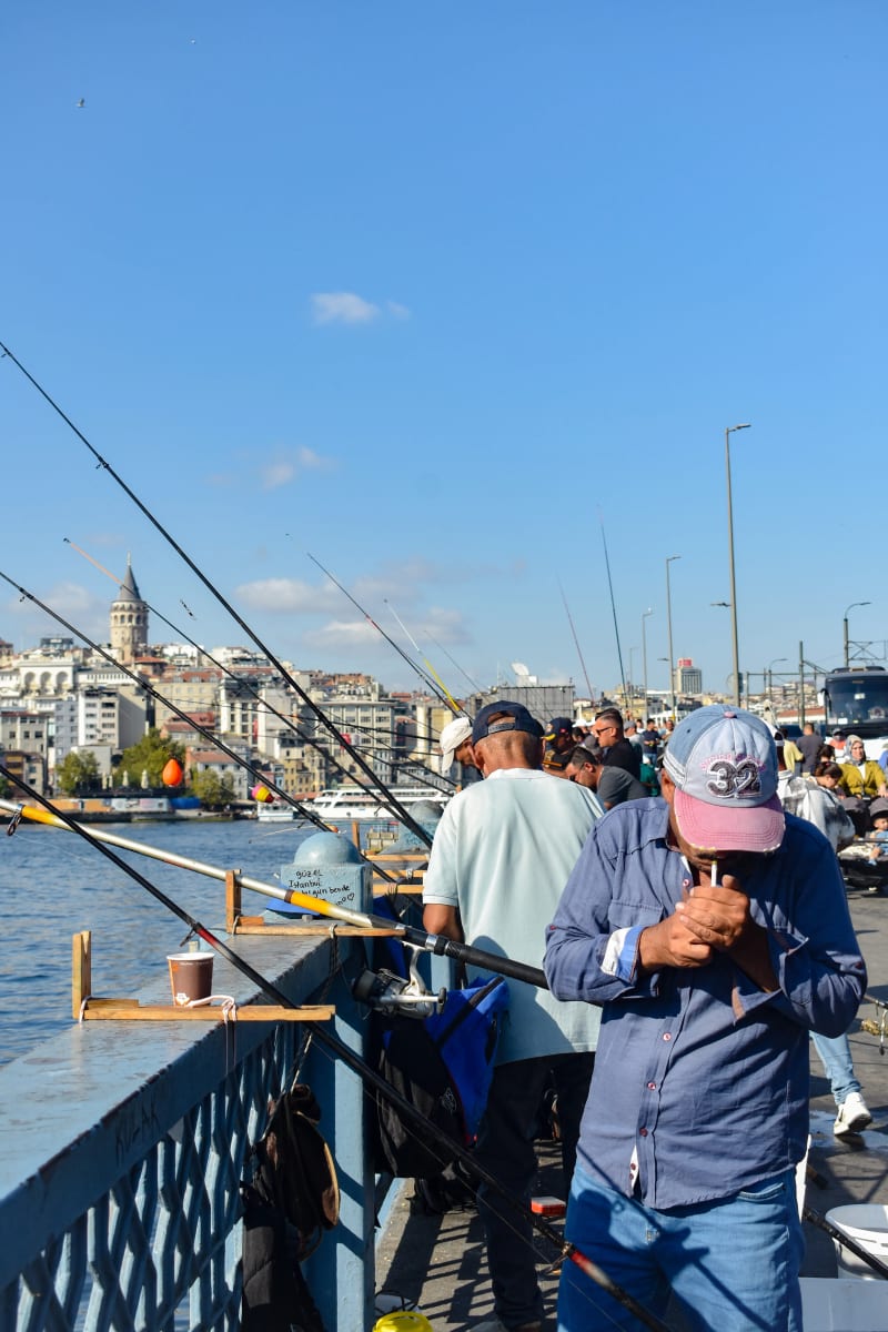 Fishermen on the Fatih side of the Galata Bridge in Istanbul, Turkey