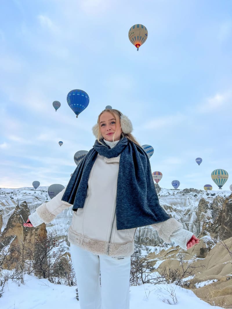 Hot air balloons flying in Cappadocia, Turkey at sunrise from the Love Valley viewpoint