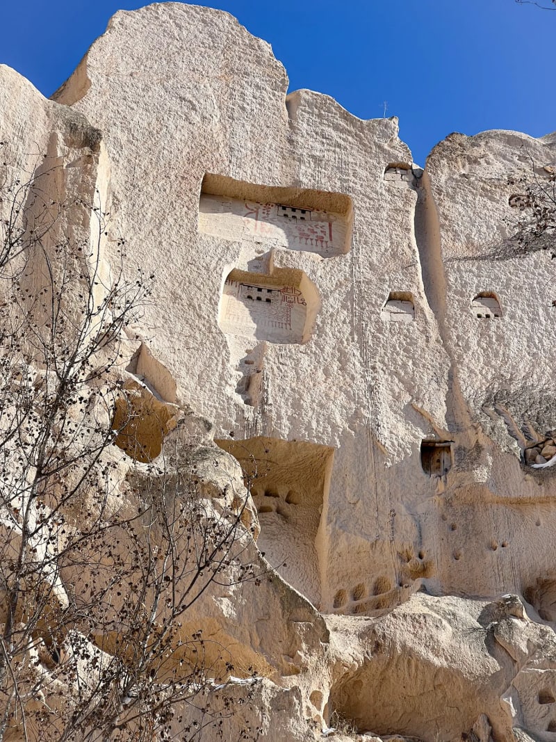 Pigeon cave houses carved into the cliffside in Cappadocia Turkey, along the Rose Valley hiking trail