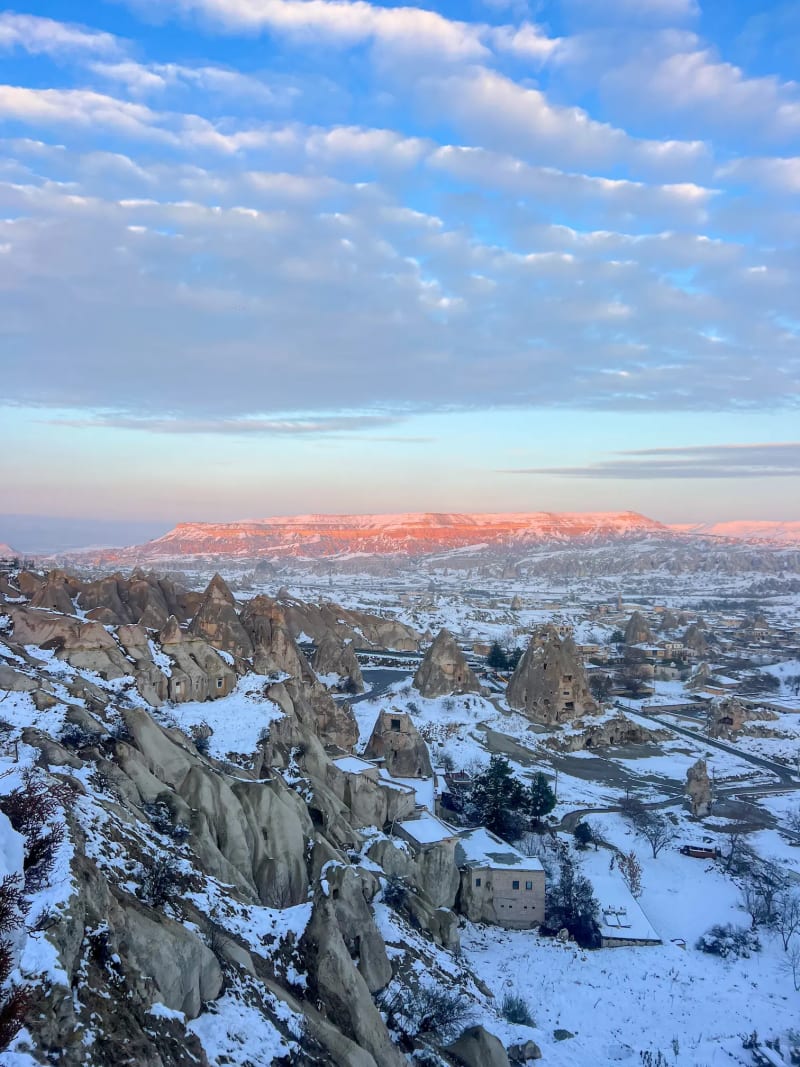 Snow-covered landscape of Göreme at a panoramic viewpoint in Cappadocia, Turkey, during the winter