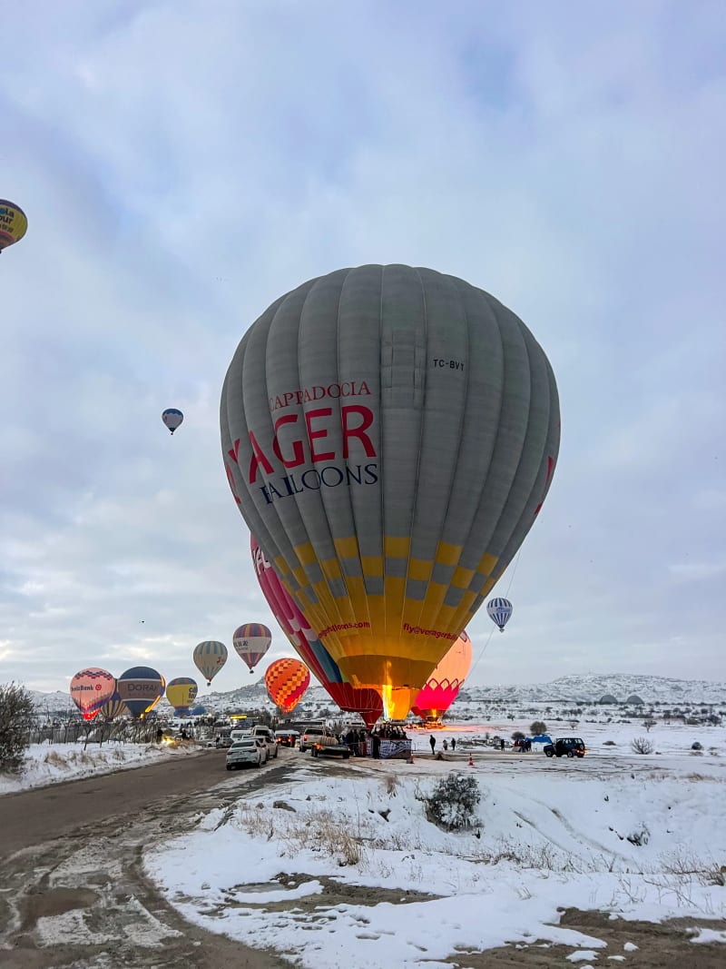 Hot air balloons inflating at the Love Valley departure spot in Cappadocia, Turkey at sunrise