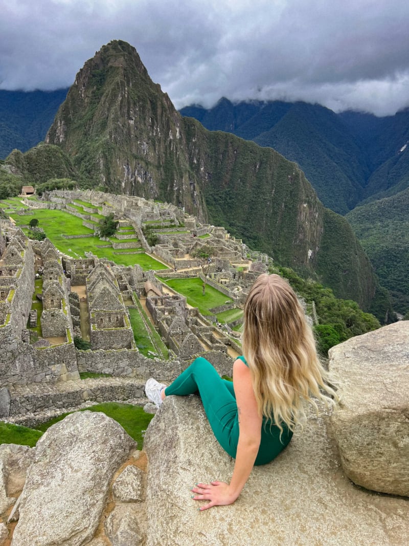 Girl sitting in front of the view at Machu Picchu