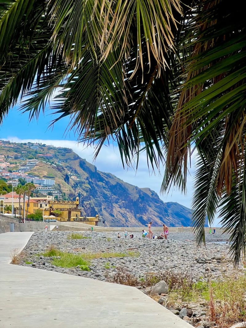 Praia do Almirante Reis beach in Funchal with fort and mountain views